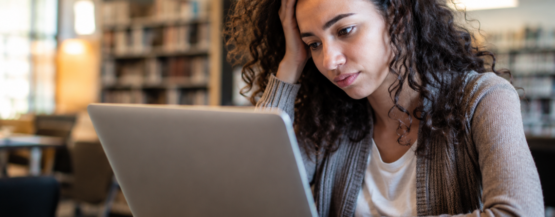 Woman with ADHD is tired at her work desk