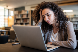 Woman with ADHD is tired at her work desk