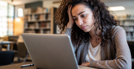 Woman with ADHD is tired at her work desk
